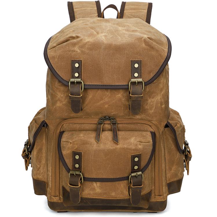 Mochila fotográfica retro de lona encerada con doble correa para cámara sin espejo y portátil.