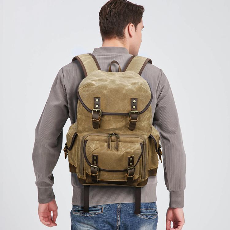 Mochila fotográfica retro de lona encerada con doble correa para cámara sin espejo y portátil.